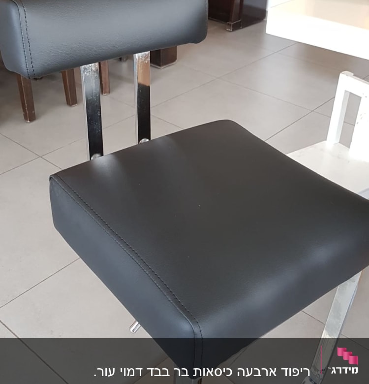 כיסא מרופד עם ריפוד שחור על רגלי מתכת